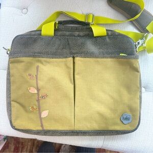 Haiku crossbody messenger/laptop bag with an embroidered leaf design.